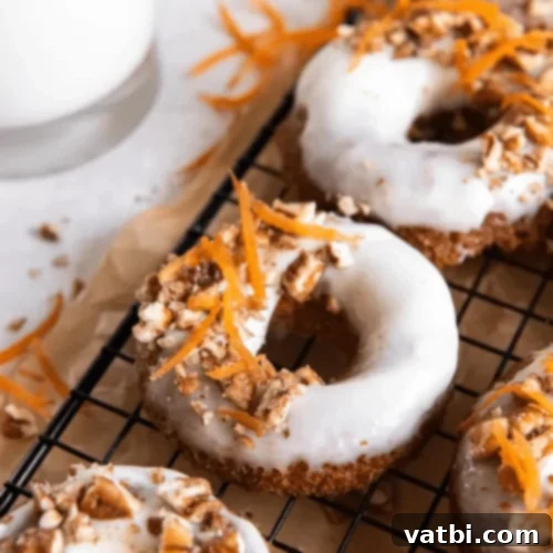 Irresistible Donut Ideas 32 Baked Carrot Cake Donuts with cream cheese frosting and pecans.