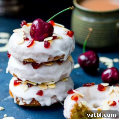 Irresistible Donut Ideas 35 Baked Cherry Bakewell Doughnuts with glace cherries and flaked almonds.