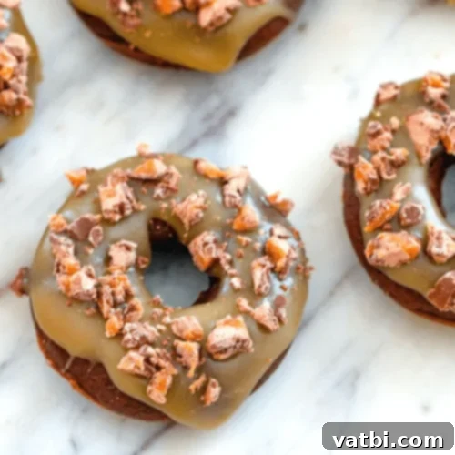 Irresistible Donut Ideas 49 Milky Way Doughnuts topped with caramel and candy pieces.