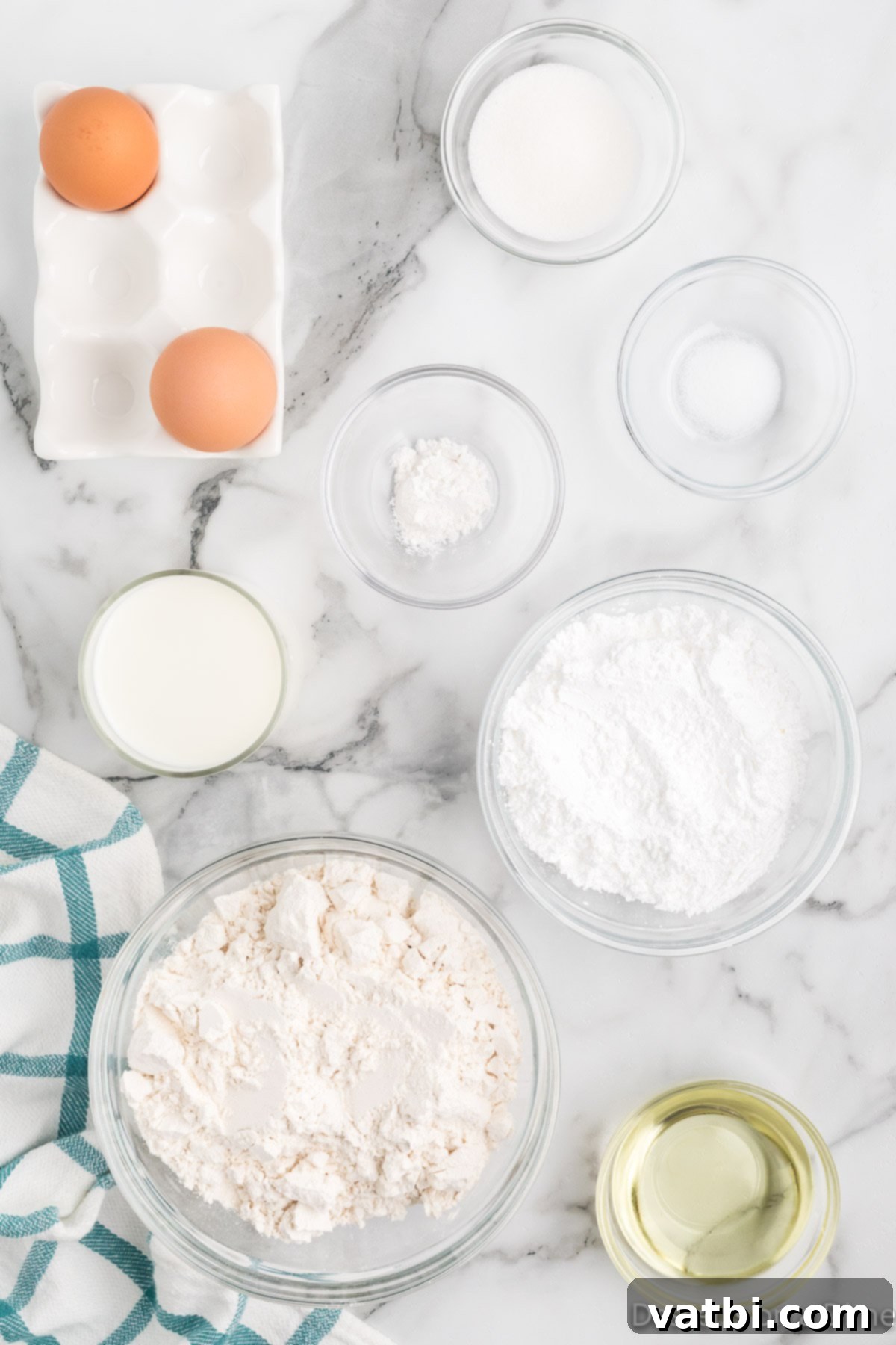 Sweet Funnel Cake Perfection 3 A collection of funnel cake ingredients including flour, sugar, baking powder, salt, milk, eggs, vegetable oil, and powdered sugar.