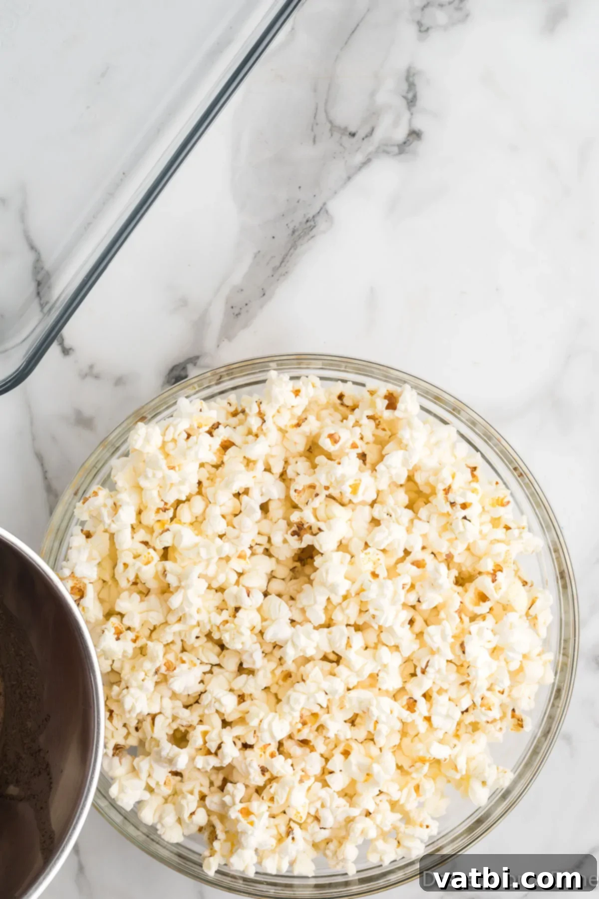 Autumn Spice Popcorn Bliss 5 Mixture poured over popcorn in bowl.