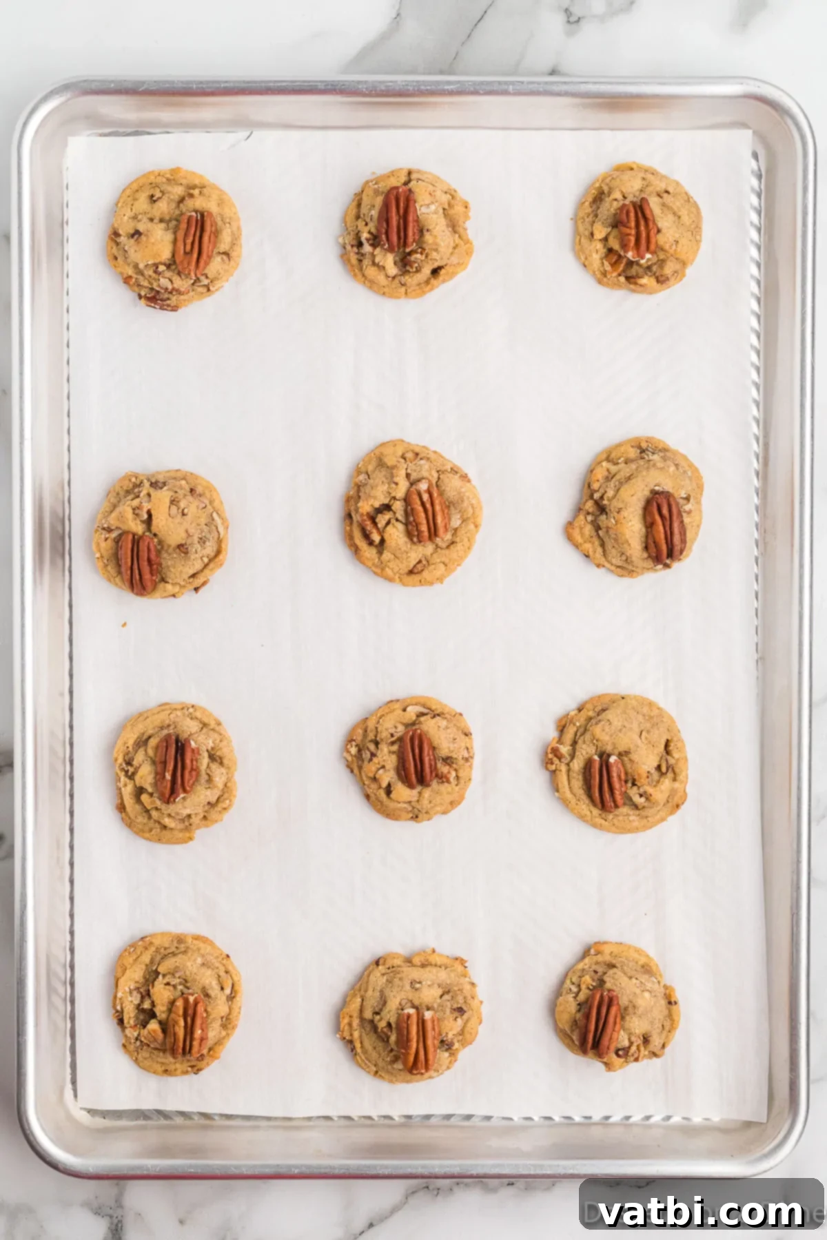 Butter Pecan Cookies 13 Cookies dropped on baking sheet and topped with pecans.