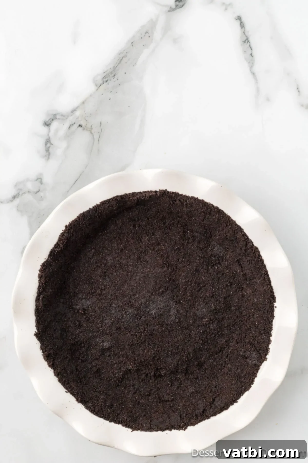 Decadent No Bake Nutella Cheesecake 6 Cookie mixture pressed into pie plate.
