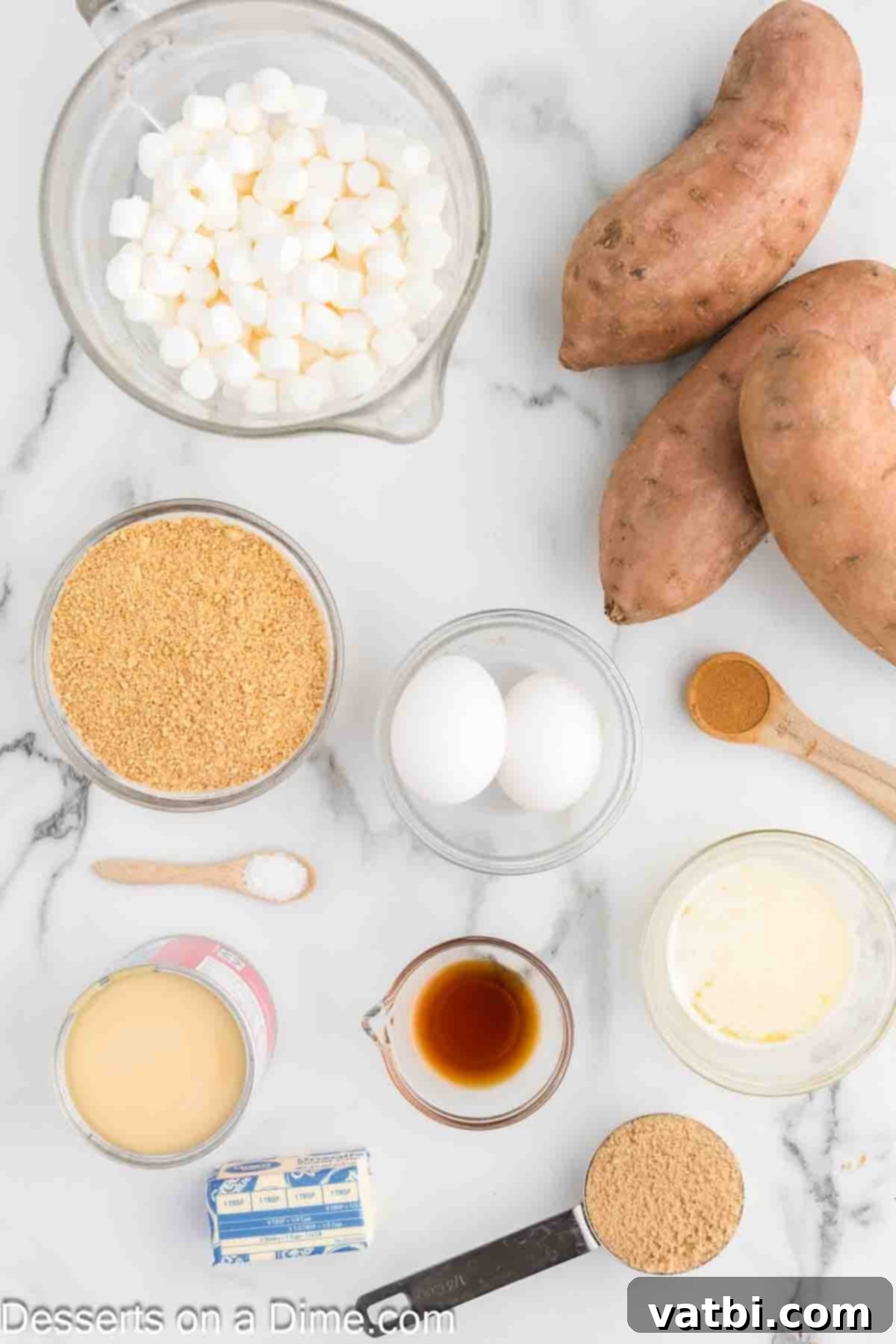 Ingredients for recipe - graham cracker crumbs, vanilla extract, fresh sweet potatoes, sweetened condensed milk, softened butter, and ground cinnamon.