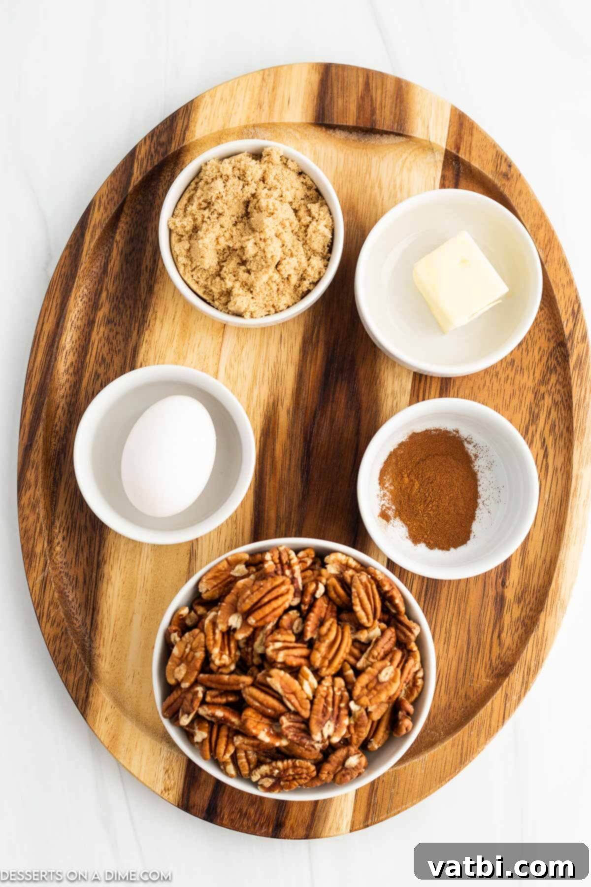 Ingredients for Air fryer candied pecans laid out: pecan halves, butter, egg whites, brown sugar, cinnamon.
