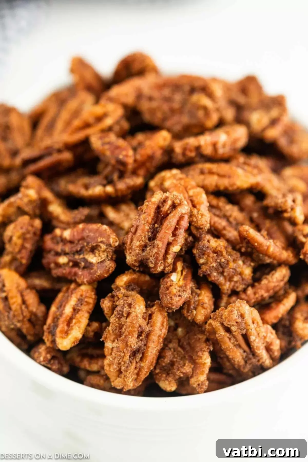 A small bowl overflowing with finished, crispy Air fryer candied pecans, ready to be enjoyed.