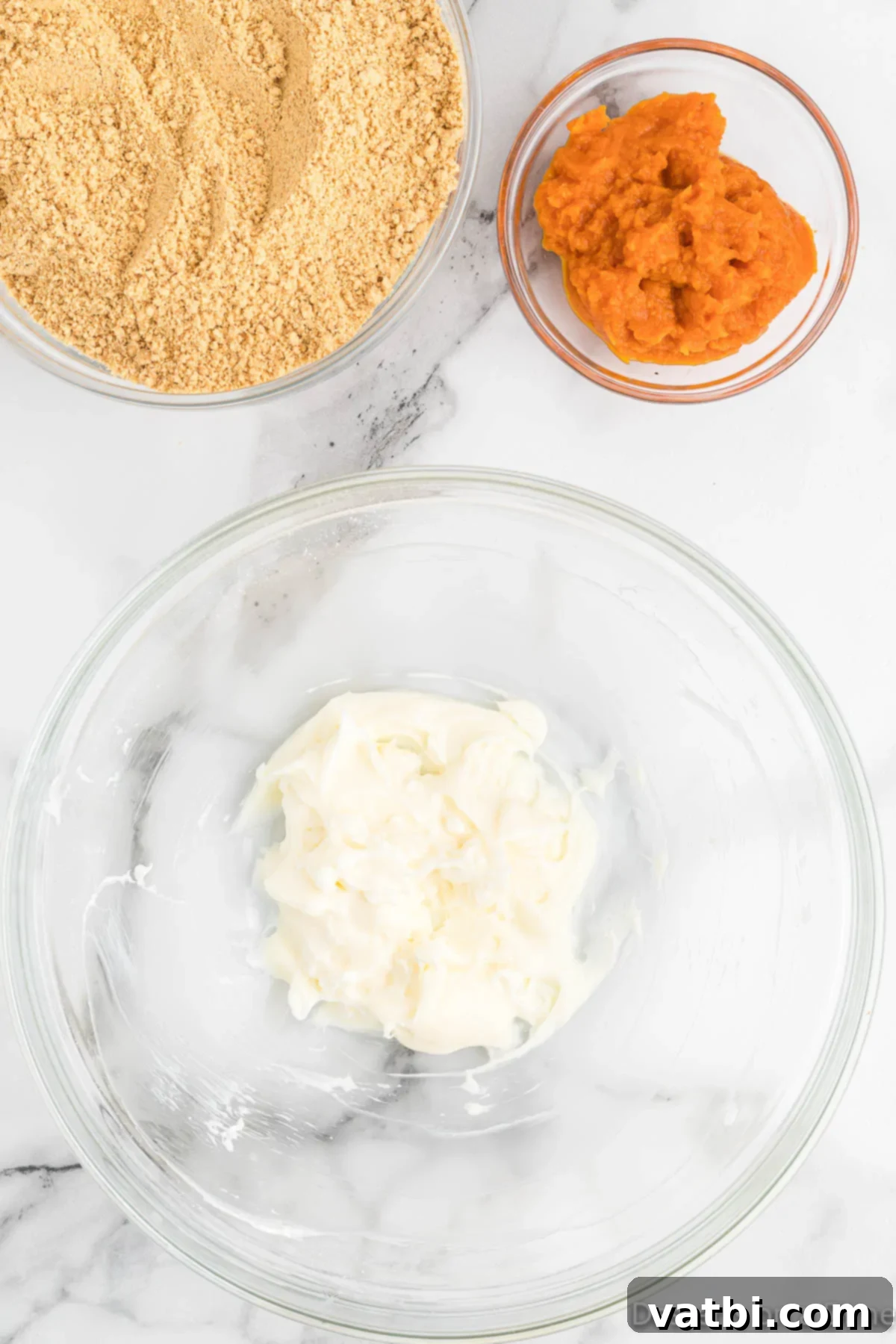 Pumpkin Spice Truffles 4 Cream cheese and powdered sugar in a bowl, being mixed until creamy.