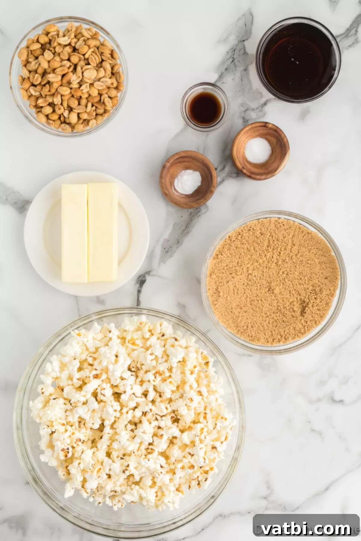 Buttery Toffee Bliss Popcorn 3 Various ingredients for butter toffee popcorn laid out on a table, including popcorn kernels, brown sugar, butter, and corn syrup.