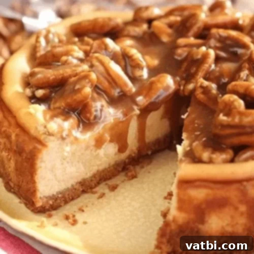 Caramel Pecan Cheesecake with a generous topping of pecans and caramel sauce.