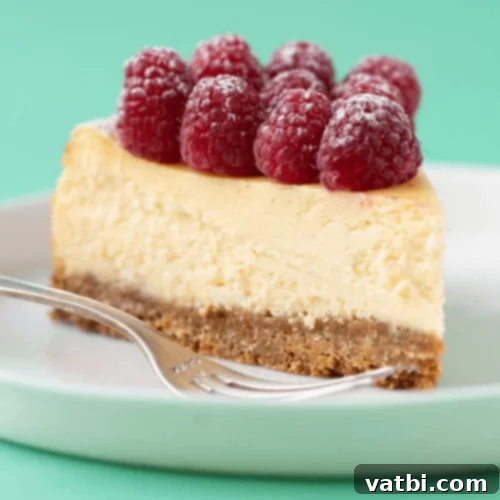 White Chocolate Cheesecake topped with fresh raspberries.
