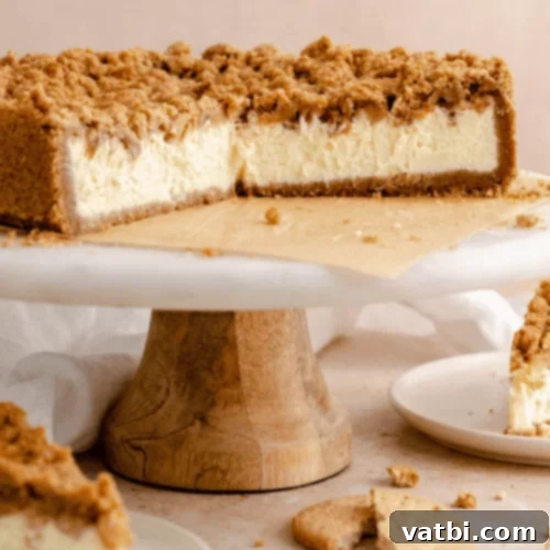Apple Crumble Cheesecake slice with a warm crumble topping.