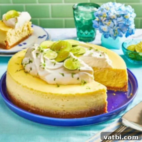 Key Lime Cheesecake slice with whipped cream and lime zest.