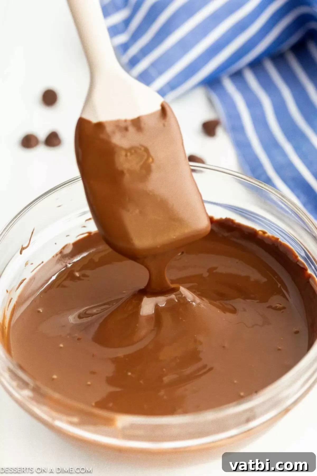 Melt Chocolate Chips Perfectly Every Time 4 Melted chocolate chips being stirred in a bowl to achieve a smooth consistency.