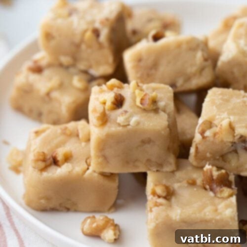 55 Festive & Easy Christmas Fudge Ideas 6 Maple Walnut Fudge squares with visible walnuts.