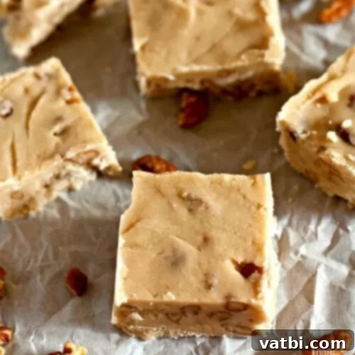 55 Festive & Easy Christmas Fudge Ideas 7 Butter Pecan Fudge squares with visible pecans.