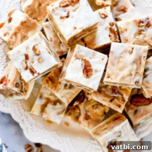 55 Festive & Easy Christmas Fudge Ideas 16 Pralines and Cream Fudge squares, with visible pecan pieces.