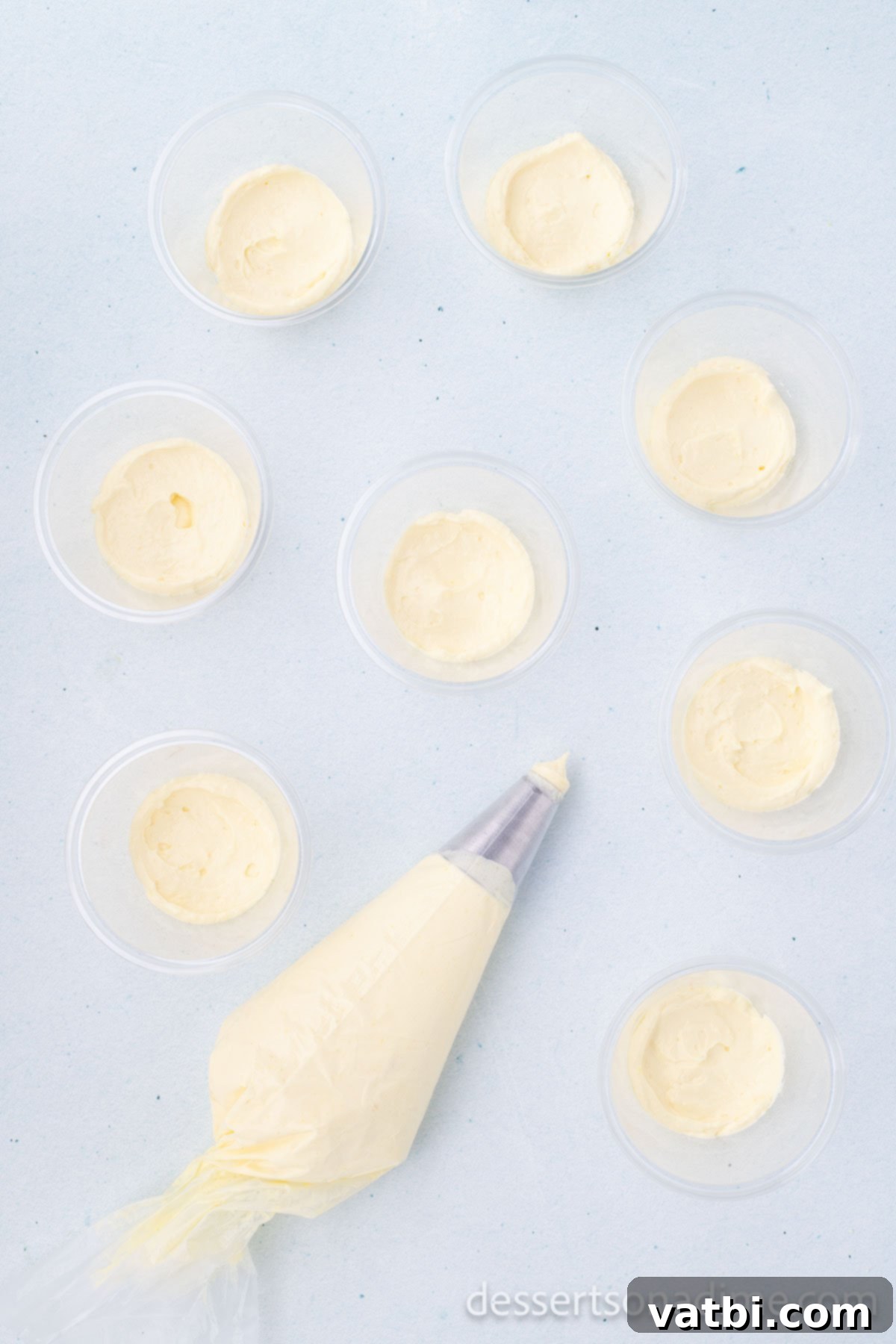 No-Bake Beach Pudding Cups 7 Pudding mixture being piped or spooned into clear individual cups.