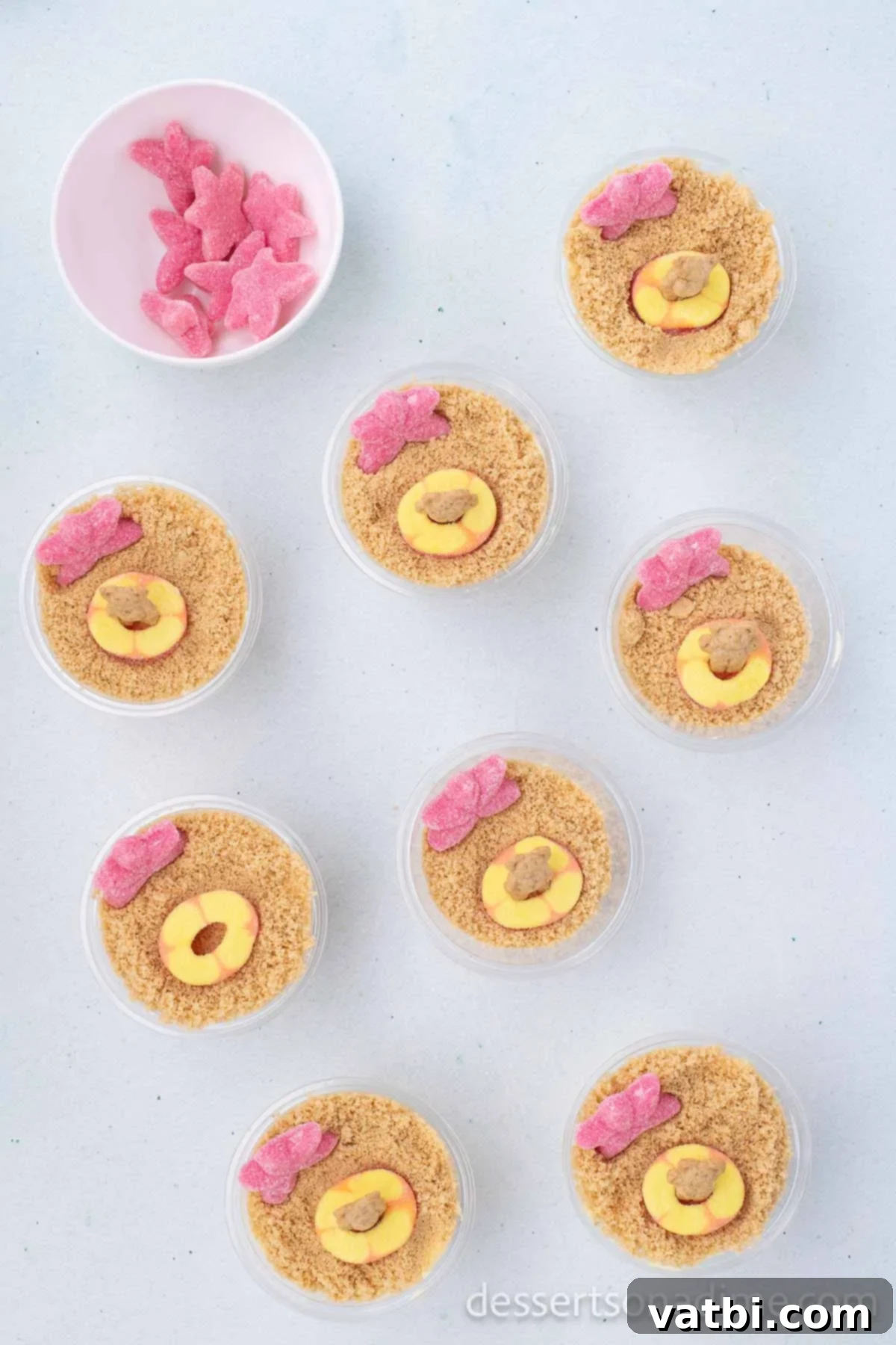 No-Bake Beach Pudding Cups 8 Candy and Teddy Grahams layered on top of the pudding and cookie crumbs to look like beach floats and swimmers.