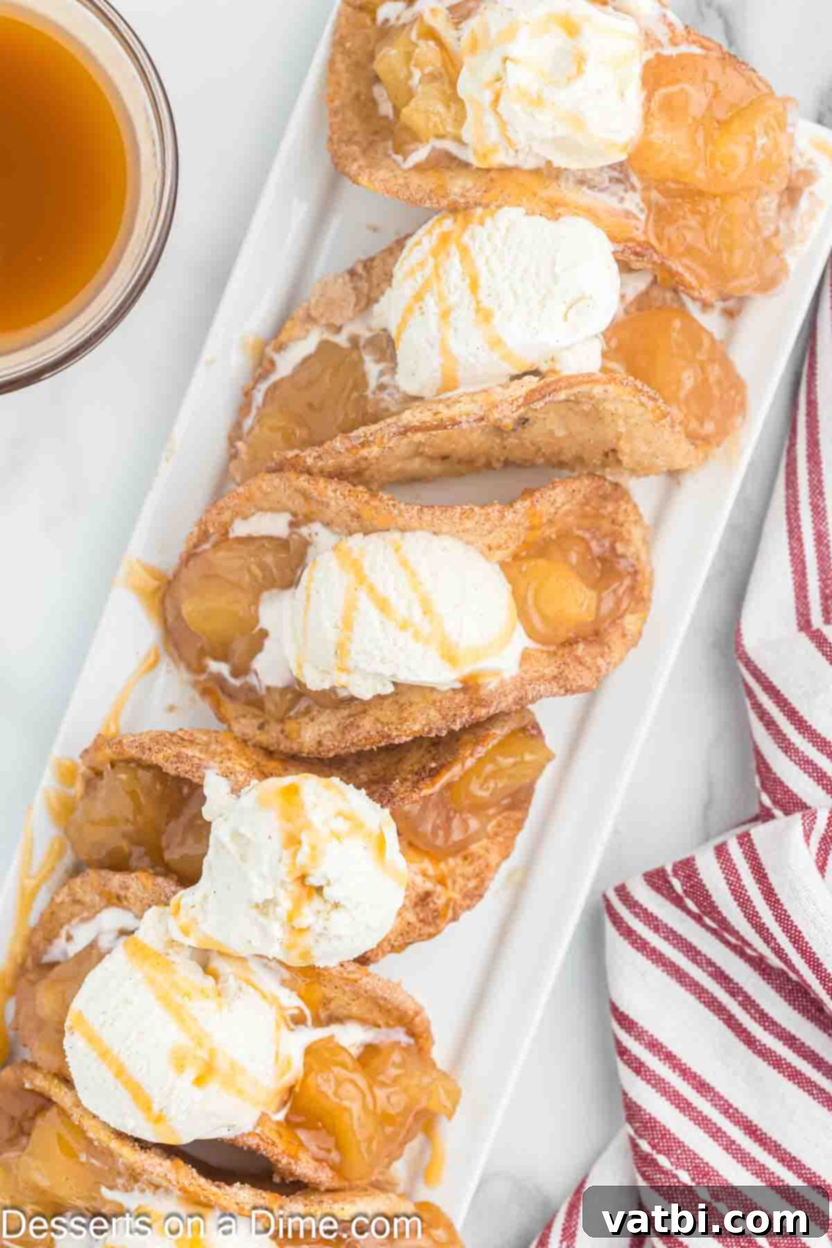 Crispy Apple Pie Wraps 11 Apple Pie Tacos topped with ice cream on a plate