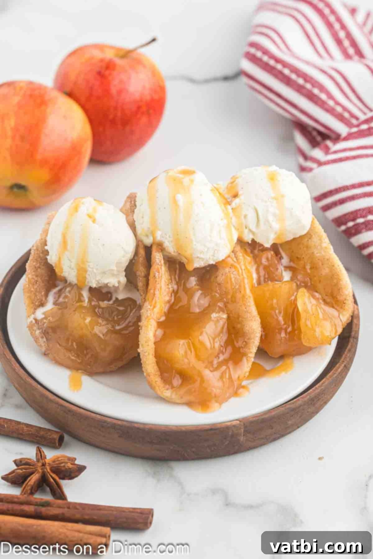 Crispy Apple Pie Wraps 12 Apple Pie Tacos topped with ice cream on a plate
