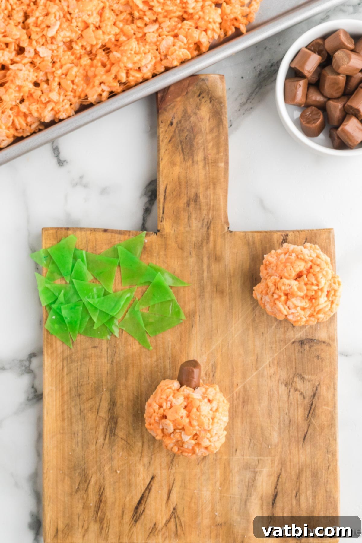 Autumn Rice Krispie Pumpkin Treats 12 Mixture formed into pumpkins.