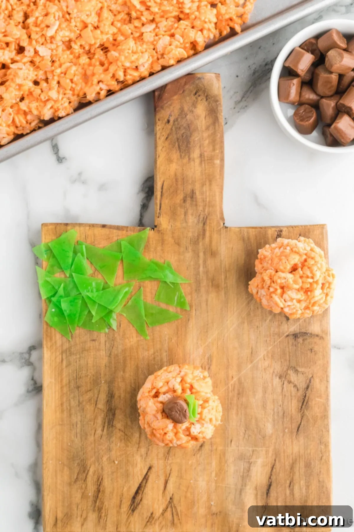 Autumn Rice Krispie Pumpkin Treats 14 Stems and leaves added to each pumpkin.