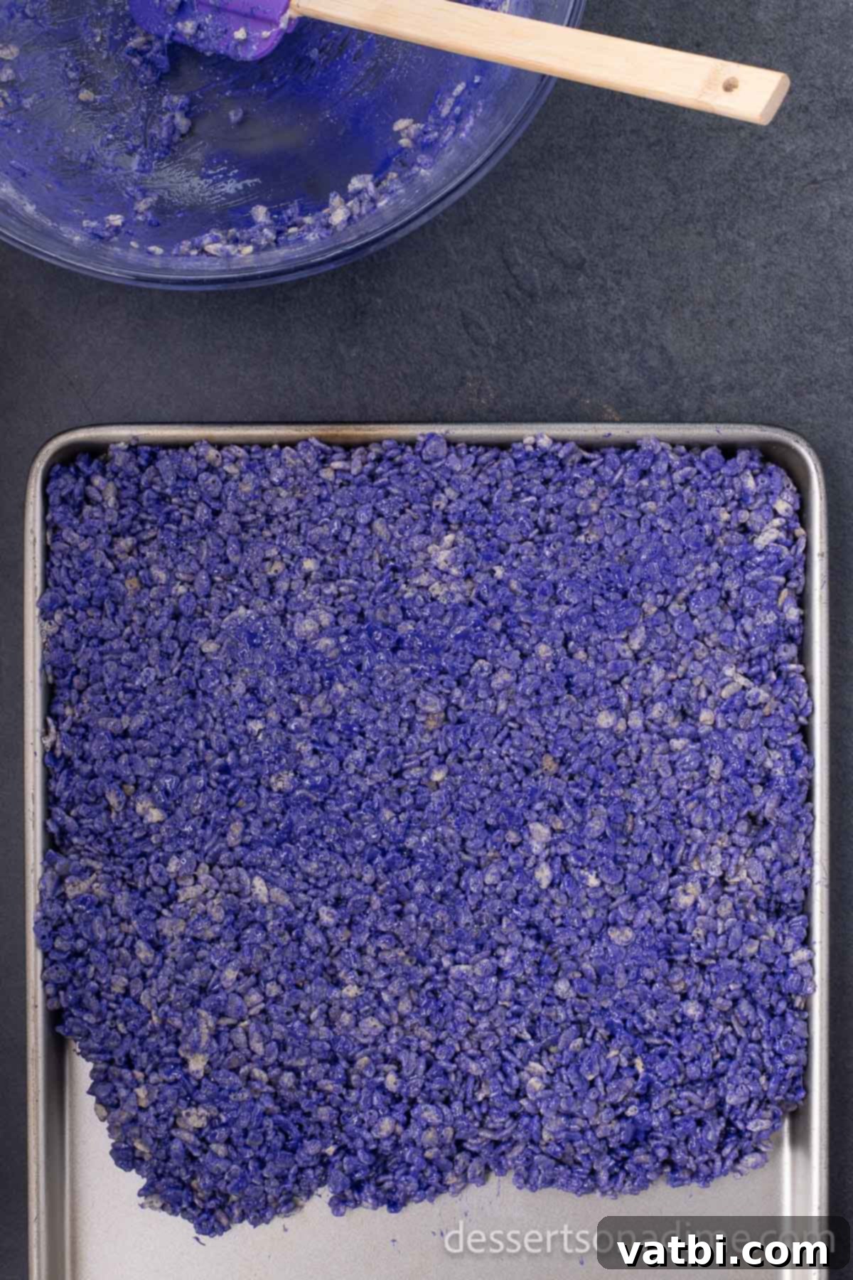 Monster Mash Krispie Treats 6 Step 5: Spread the colored Rice Krispie mixture into a pan to cool.