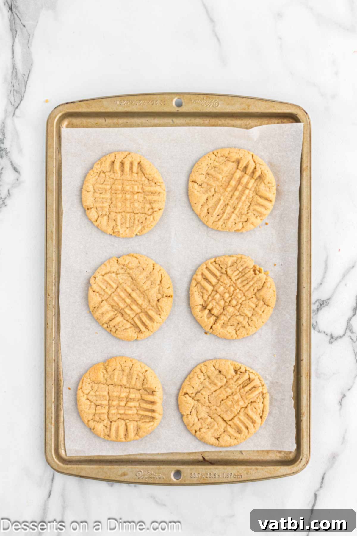 Simple Spooky Halloween Spider Bites 12 Cookies baked and cooling on baking sheet.