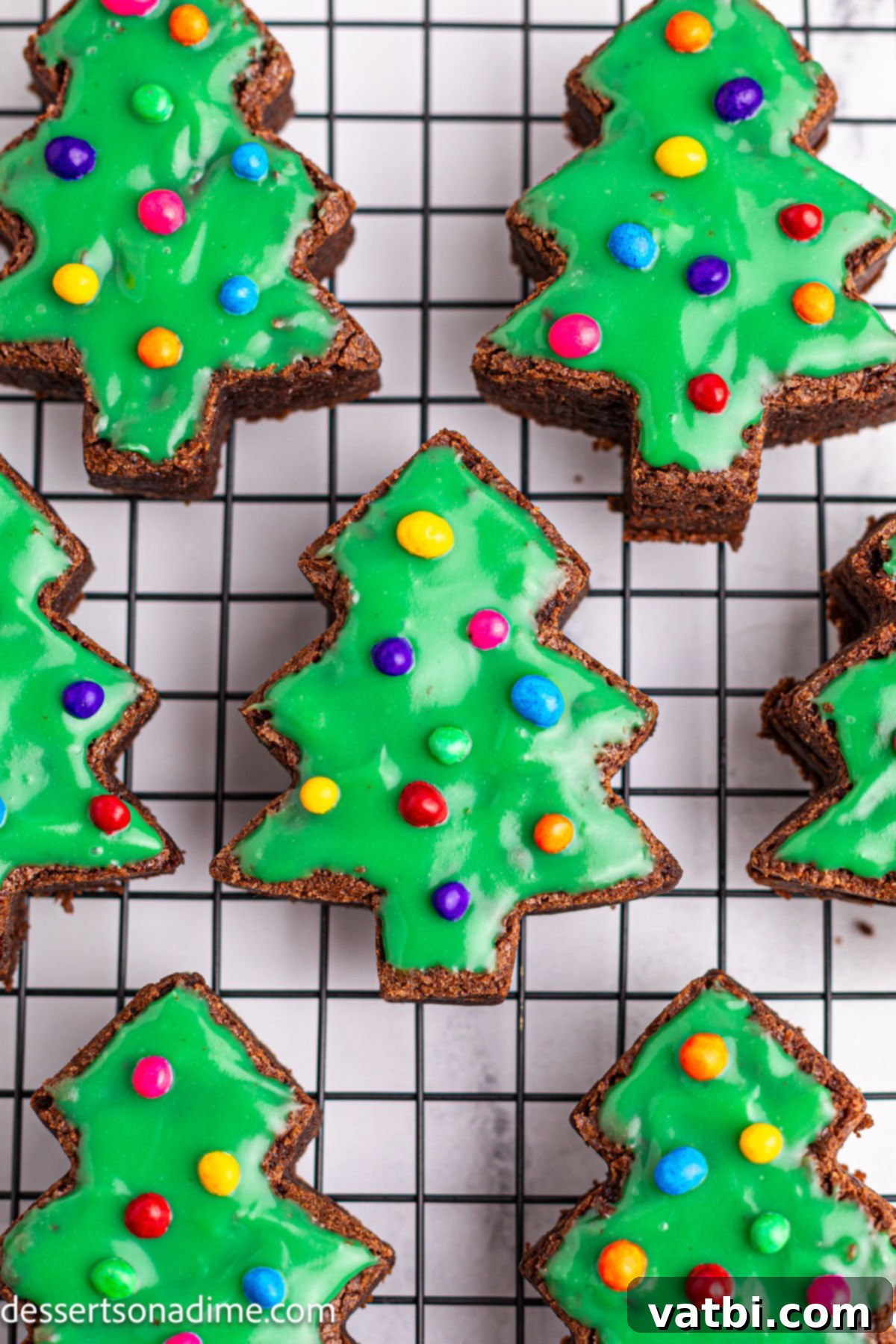 Little Debbie Inspired Christmas Tree Brownies 11 Decorated Christmas tree brownies resting on a wire rack, allowing the green topping to set completely.