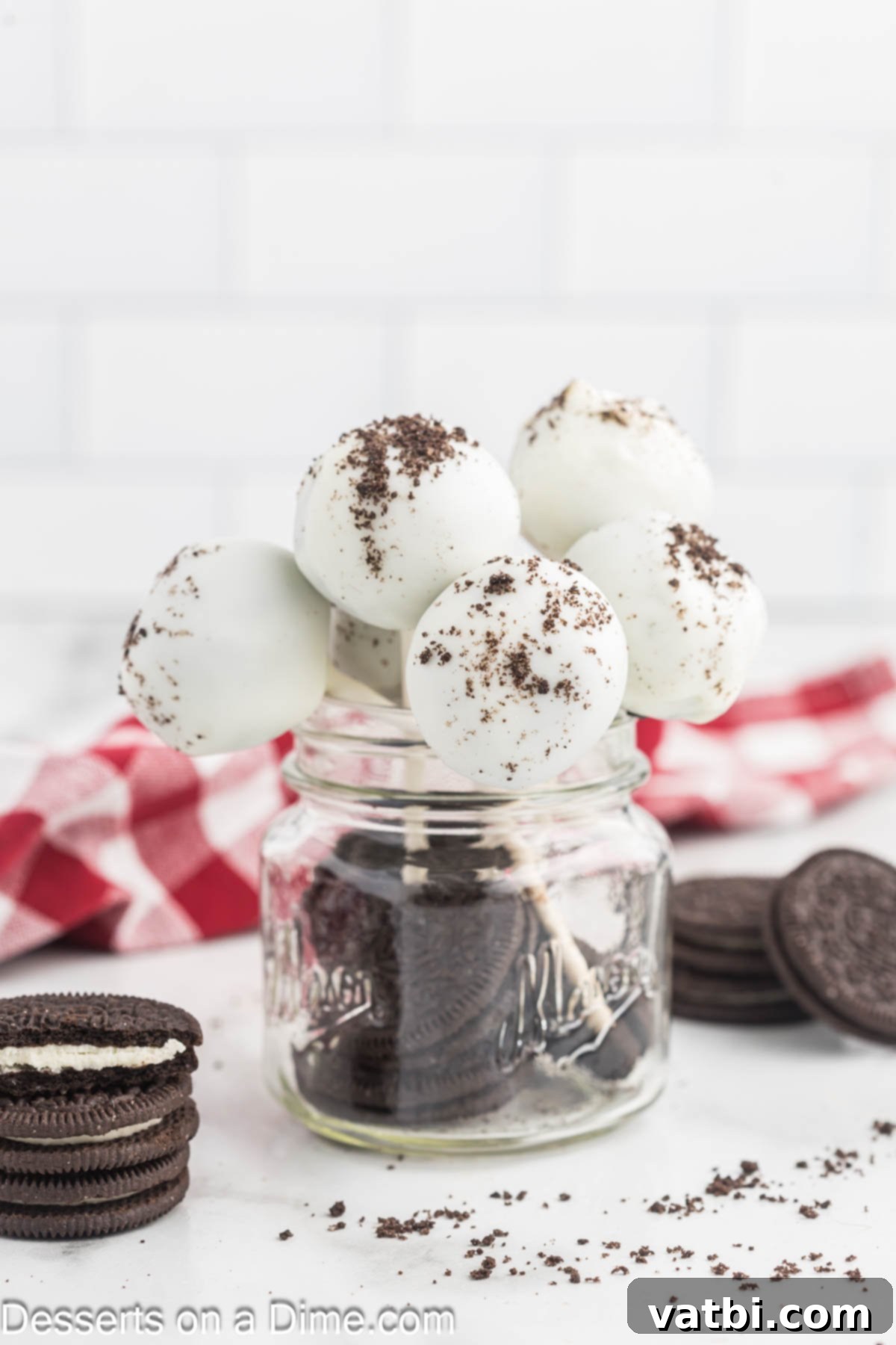 Oreo Cake Pops artistically arranged in a rustic mason jar, showcasing their delightful appearance and perfect for gifting or serving.