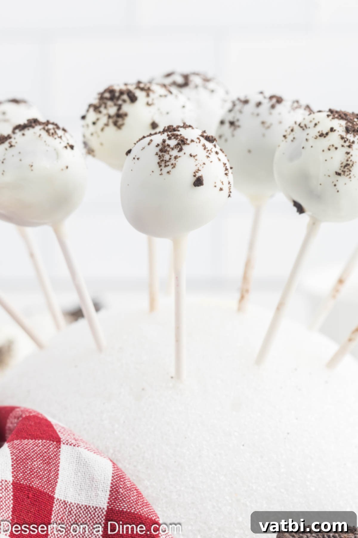Finished Oreo Cake Pops inserted upright into a block of Styrofoam, allowing the candy coating to dry and set completely.