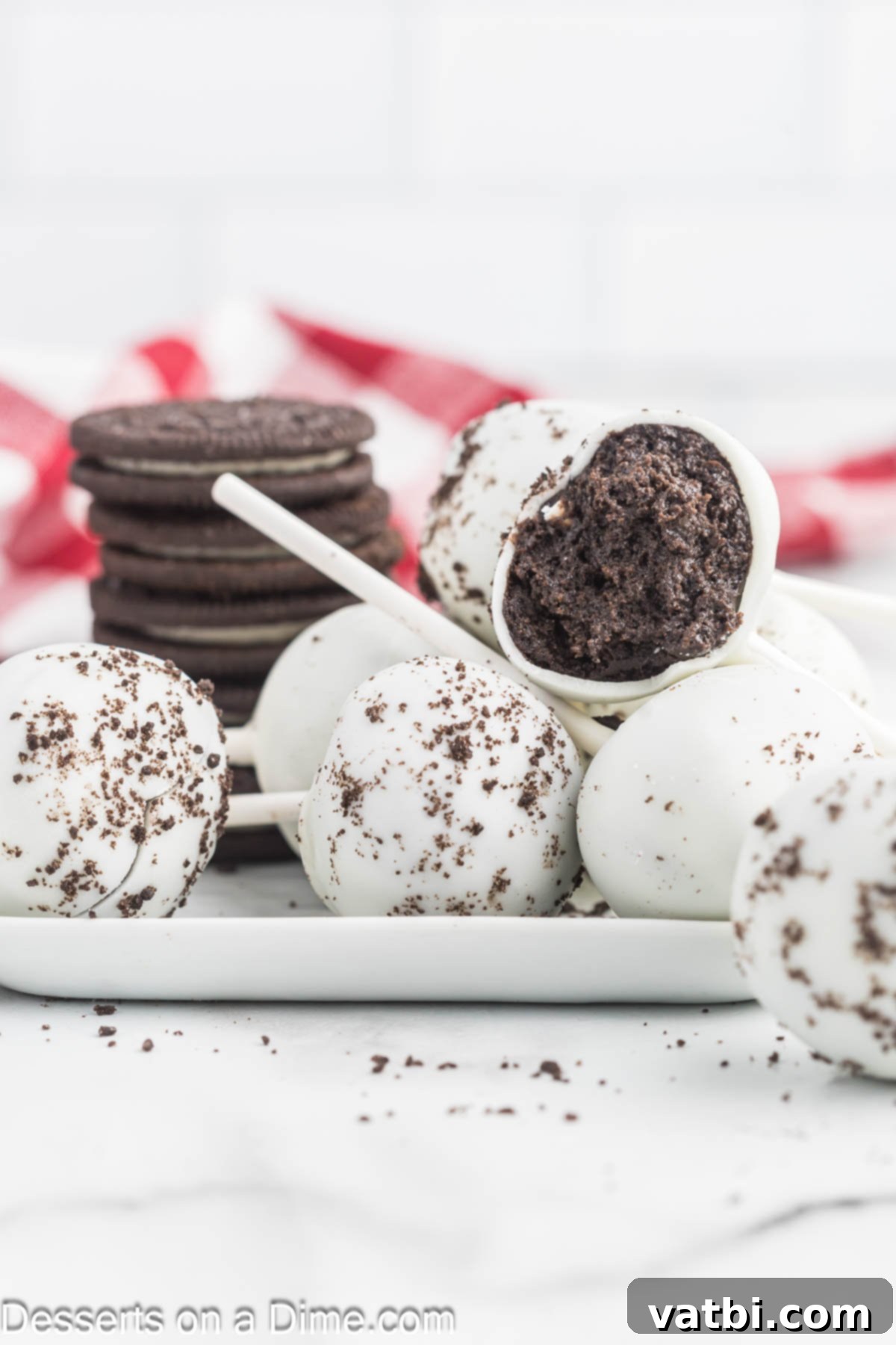 A generous pile of freshly made Oreo Cake Pops, beautifully coated and topped with crushed Oreos, arranged on a platter ready for serving or sharing at a party.