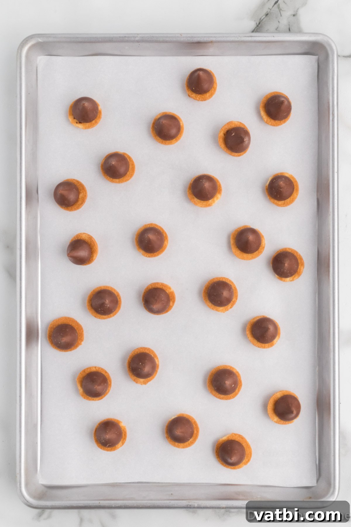 Hershey Kisses placed on vanilla wafers. 