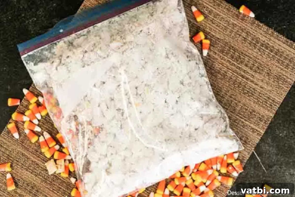 Monster Munch Puppy Chow 4 Powdered sugar in a ziplock bag combined with cereal mixture, being shaken.