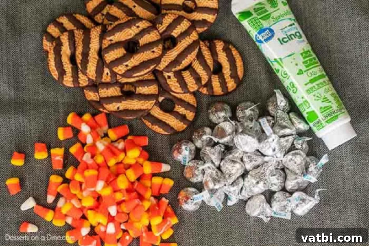 Witch hat cookies are the perfect no bake treat and they are easy to make for Halloween with hershey kisses. Halloween witch hat cookies decorated make the cutest treat for parties and more. #dessertonadime #witchhatcookies #harrypotter Supplies needed for witch hat cookies: candy corn, fudge stripe cookies, Hershey's chocolate kisses, and green decorating icing.