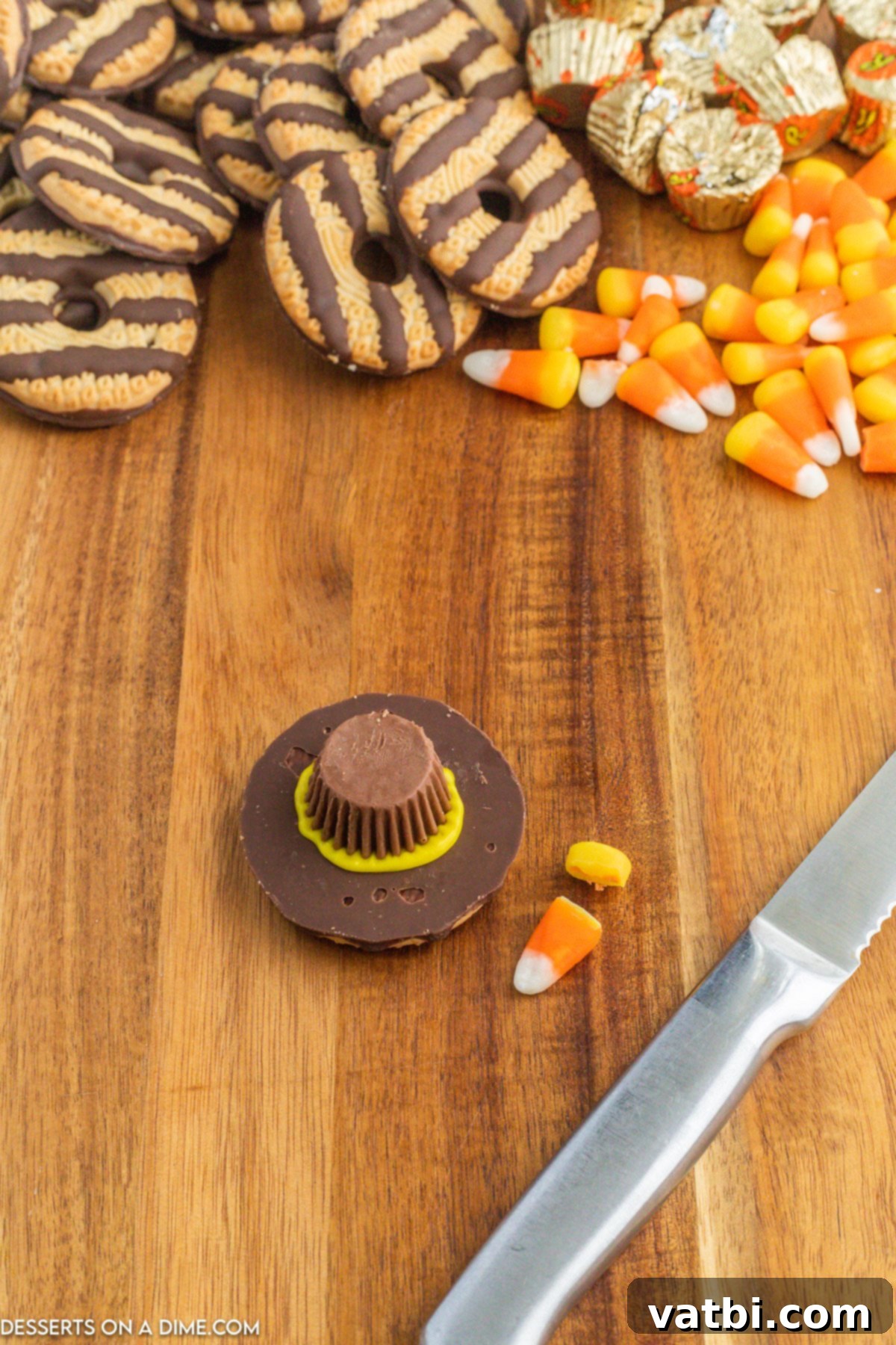 Yellow icing seeping out from under the Reese's cup, gracefully forming the distinct brim of the pilgrim hat cookie.