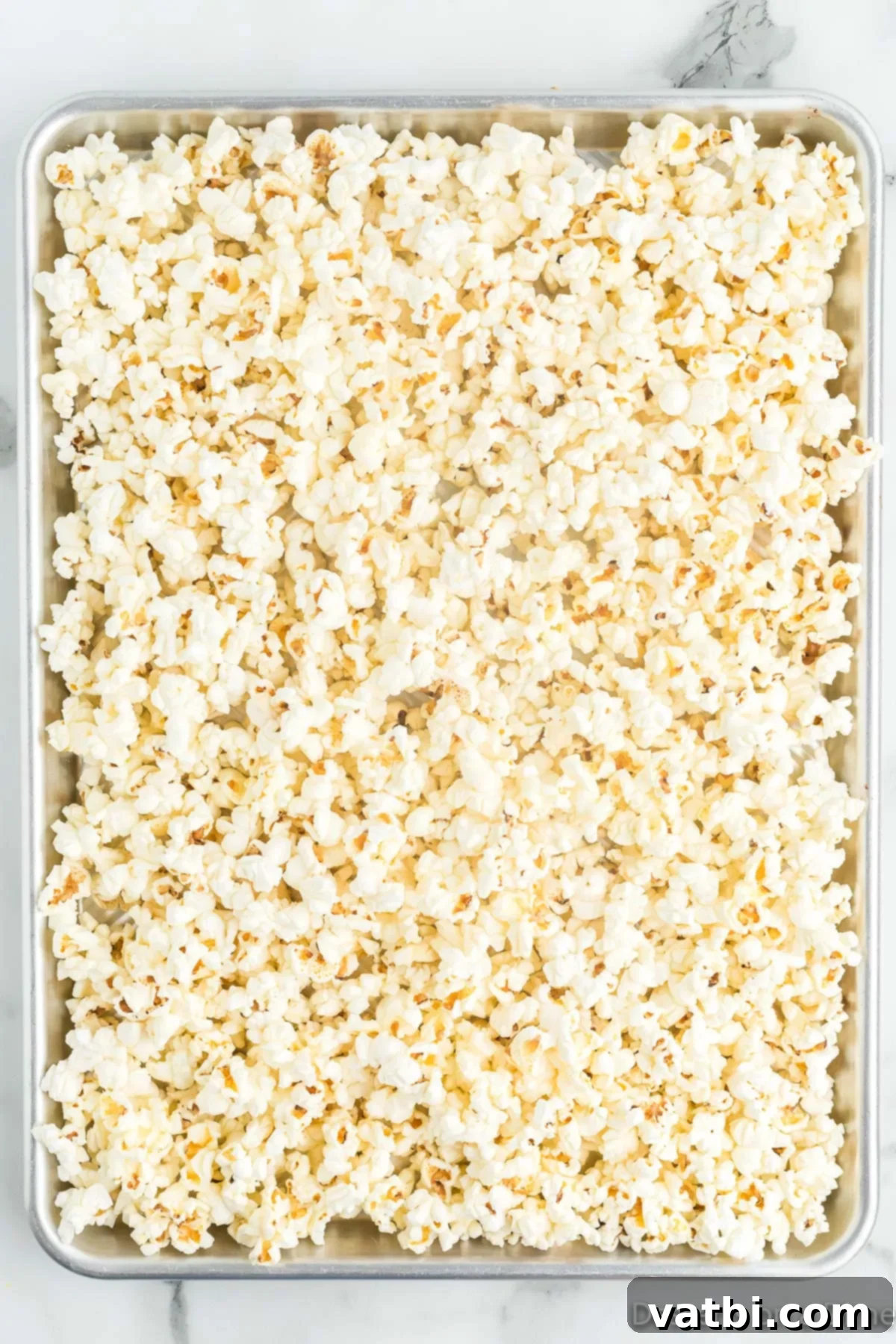 Fright Night Popcorn 4 Popcorn on a baking sheet, spread into a single layer.