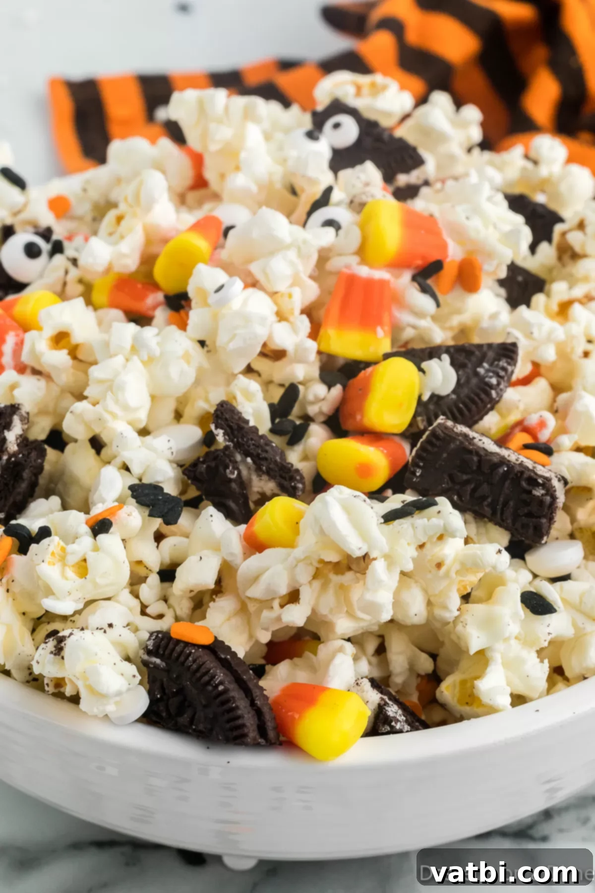 Fright Night Popcorn 8 Halloween Popcorn in a bowl, showing various candies and sprinkles mixed in.