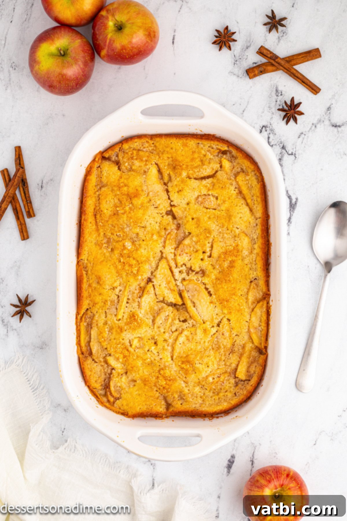 Golden Apple Cobbler Perfection 9 A freshly baked apple cobbler, golden brown on top and bubbling with apple filling, cooling on a rack after being removed from the oven.