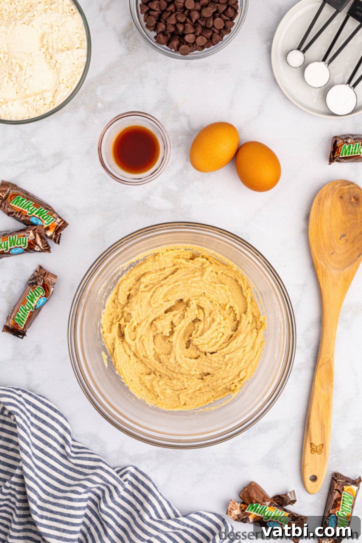 Mixing bowl with softened butter, granulated sugar, and brown sugar being creamed together.