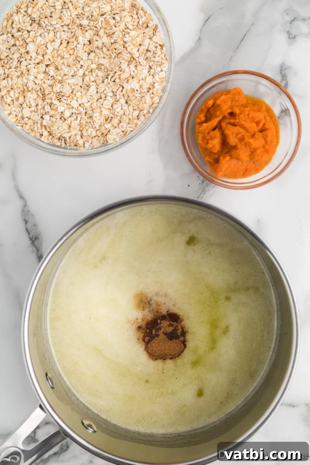 No-Bake Pumpkin Spice Treats 6 Pumpkin pie spice and pumpkin puree added to saucepan.