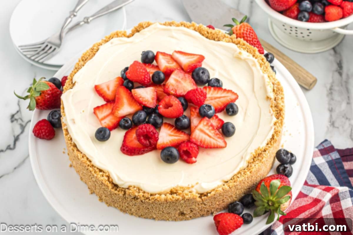 Effortless No-Bake Cheesecake 2 No Bake Cheesecake topped with vibrant fresh fruit like strawberries, blueberries, and raspberries.
