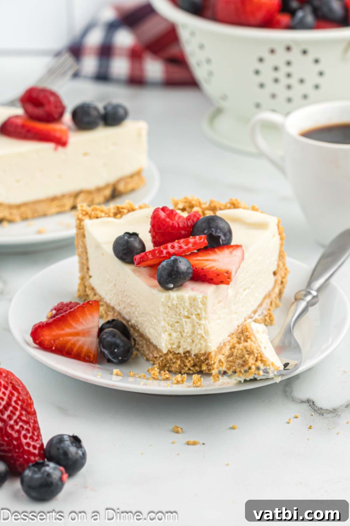 Effortless No-Bake Cheesecake 11 A delectable slice of no bake cheesecake on a white plate, showcasing its creamy texture and golden crust.