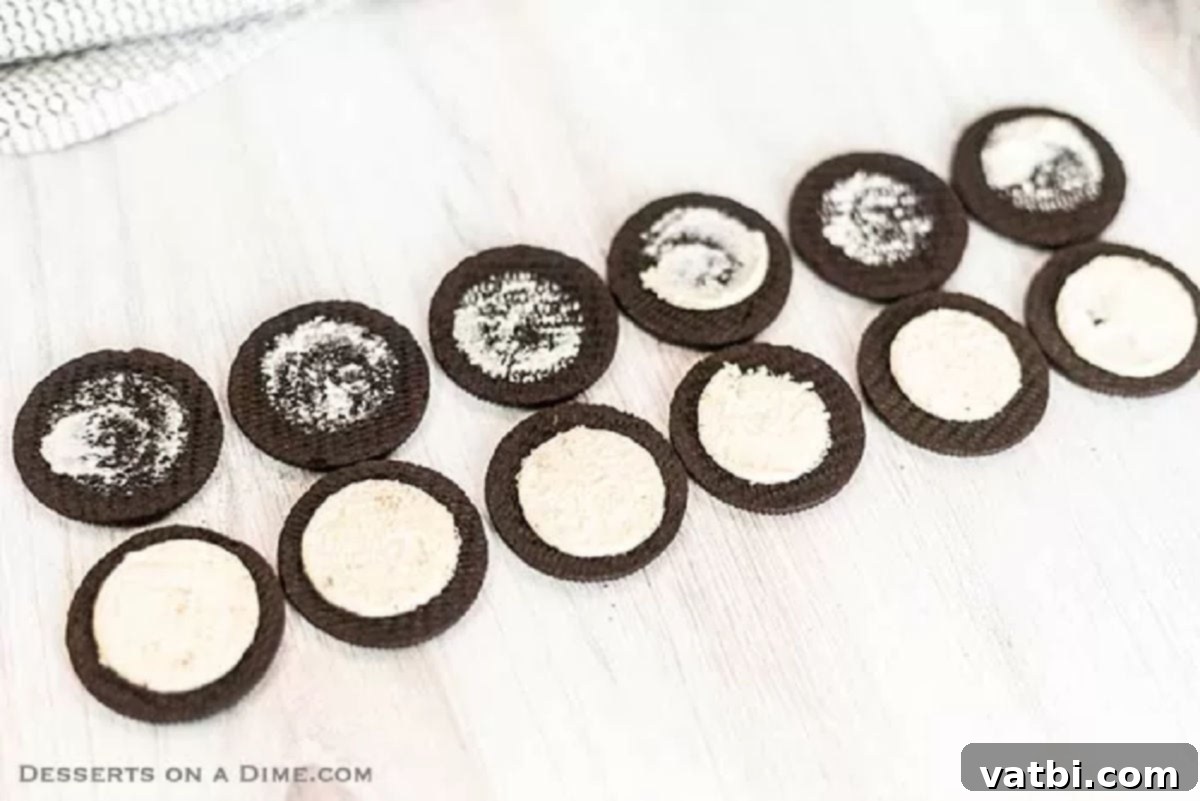 Spooky Oreo Spider Cookies 2 An Oreo cookie carefully twisted in half, showing the cream filling intact on one side.