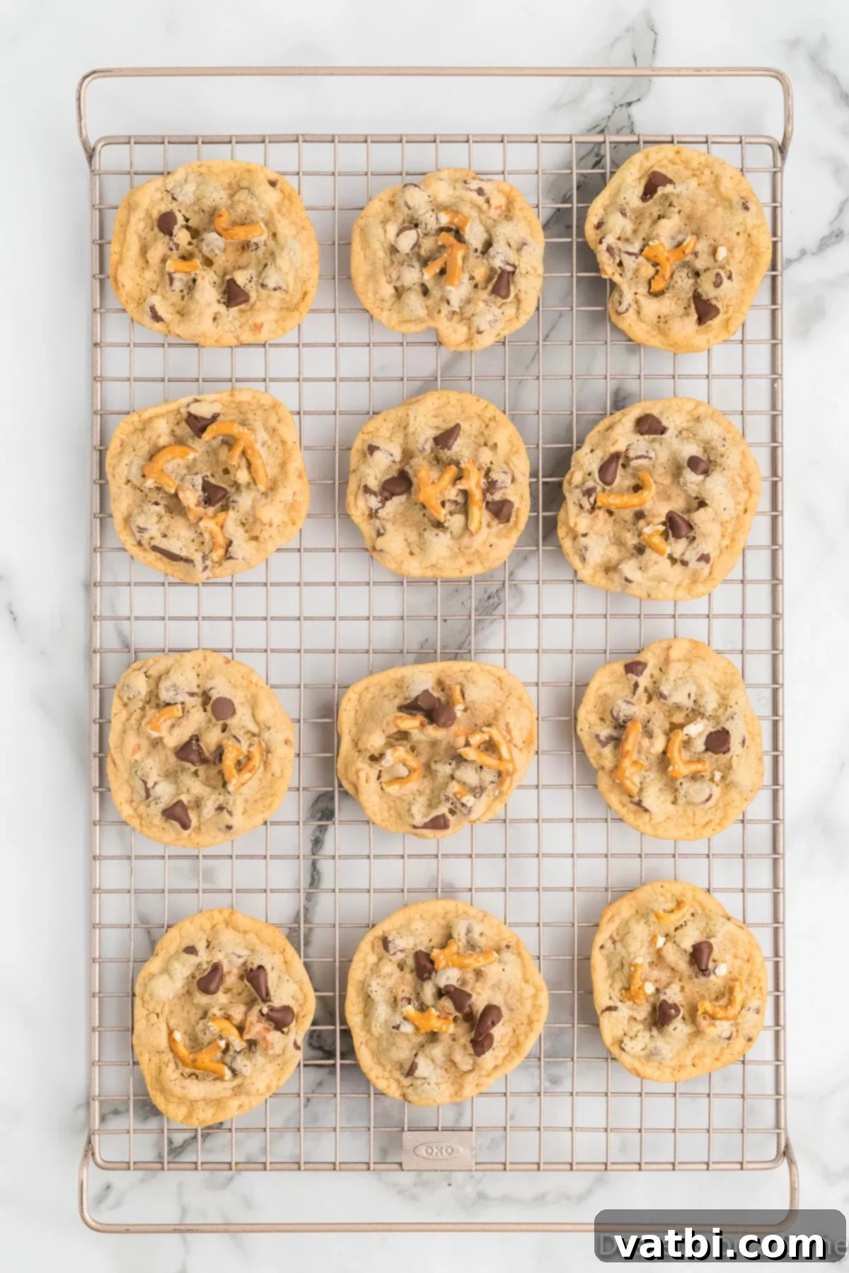 Salty Sweet Chocolate Pretzel Crunch 13 Baked chocolate chip pretzel cookies cooling on a wire rack after being removed from the oven.