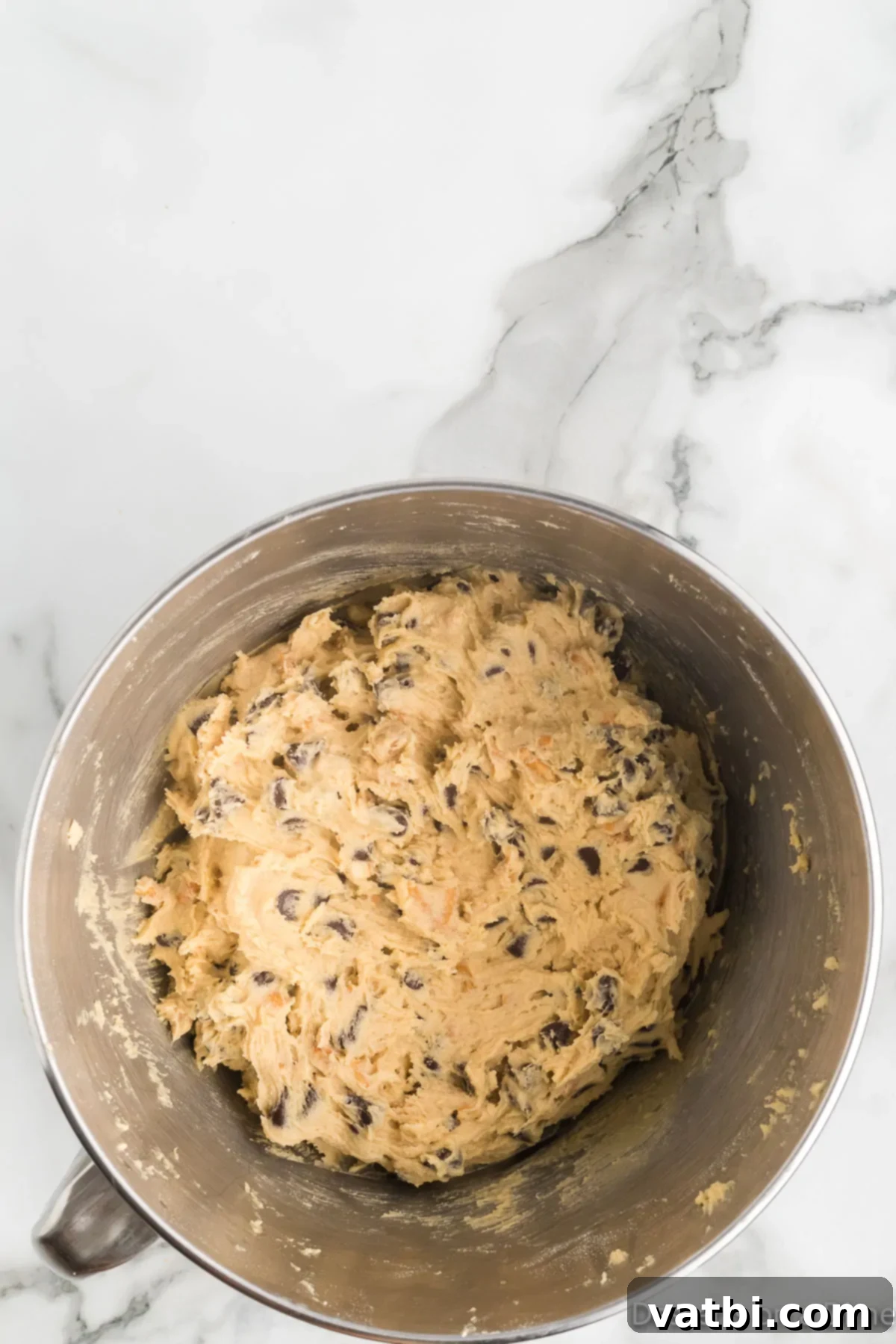 Salty Sweet Chocolate Pretzel Crunch 9 Cookie dough in a bowl, covered with plastic wrap and ready for chilling in the refrigerator.