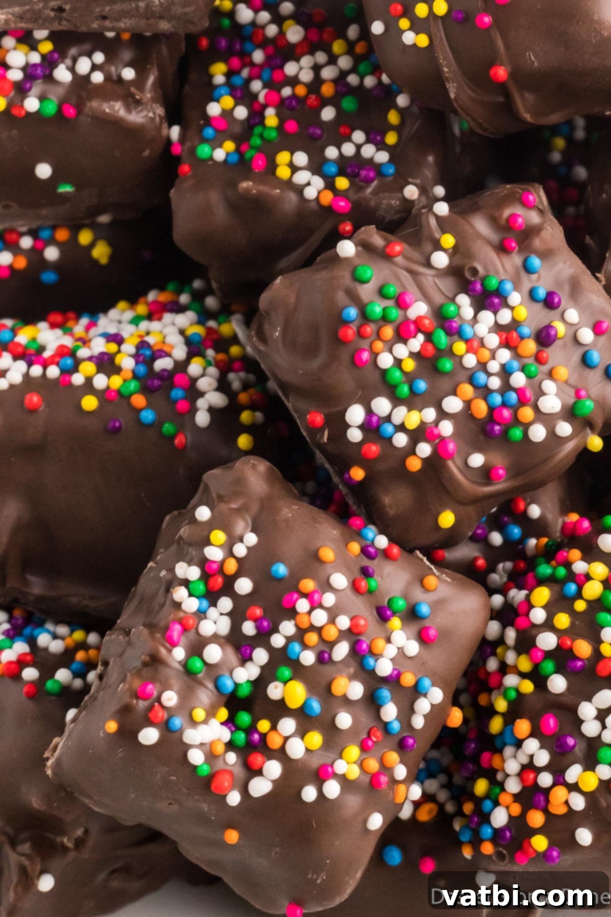 A tempting pile of homemade chocolate covered rice krispie treats, artfully arranged and ready to be enjoyed.