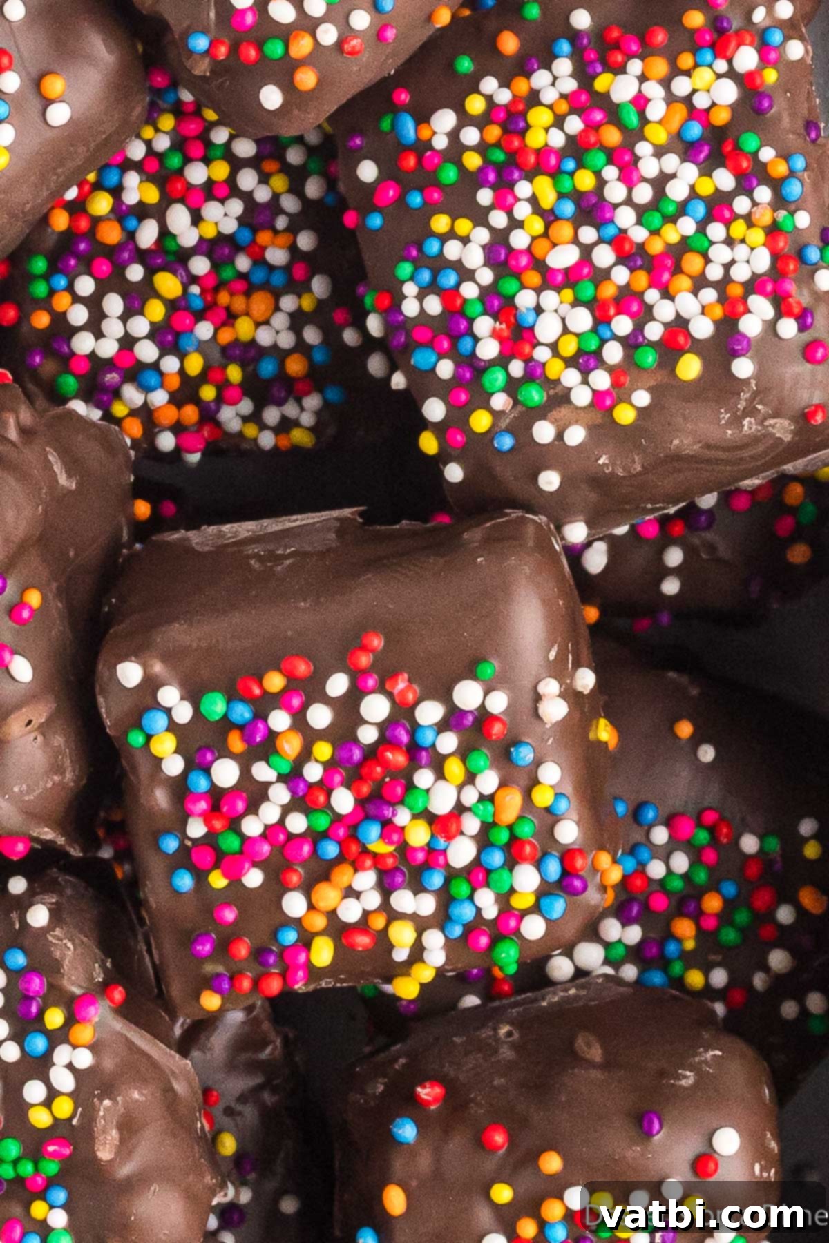 Chocolate covered rice krispie treats in a pile.