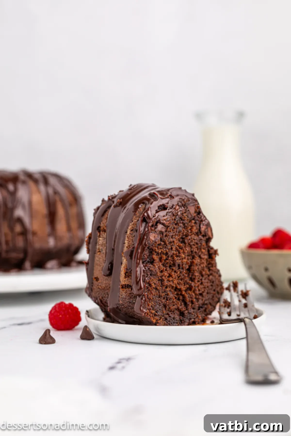 Decadent Chocolate Brownie Cake 7 Chocolate Brownie Cake sliced and served on a plate.