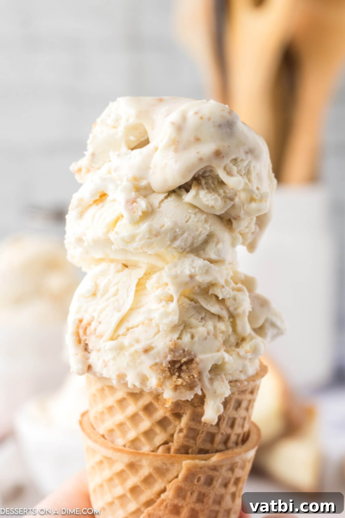 Easy No-Churn Cheesecake Ice Cream 2 Ice cream scooped and served in a cone.